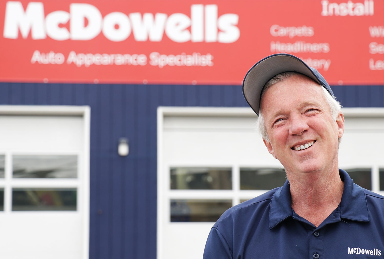 There is a picture of Bert, the Owner. He is standing in front of McDowell's building and smiling.