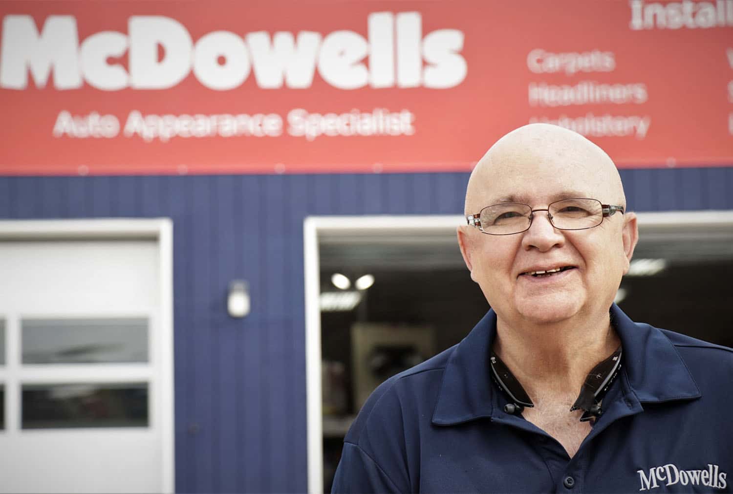 There's a picture of Paul, the Furniture Master Tech. He's standing in front of McDowell's building.