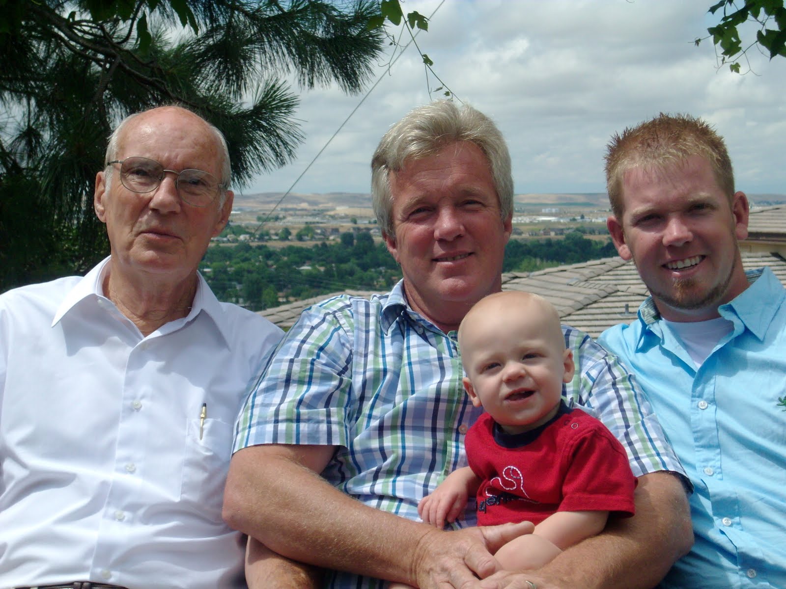 There's an image showing four people smiling: A baby, an old man, a middle-aged man, and a young man