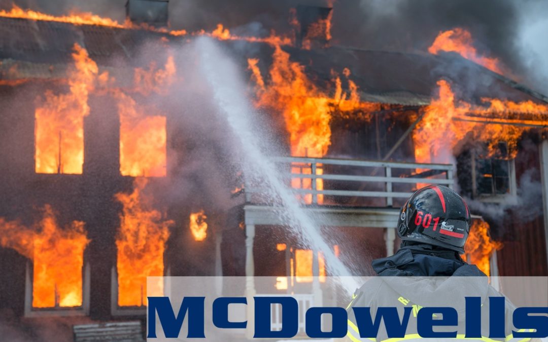 Firefighter shooting water & trying to put out a house fire